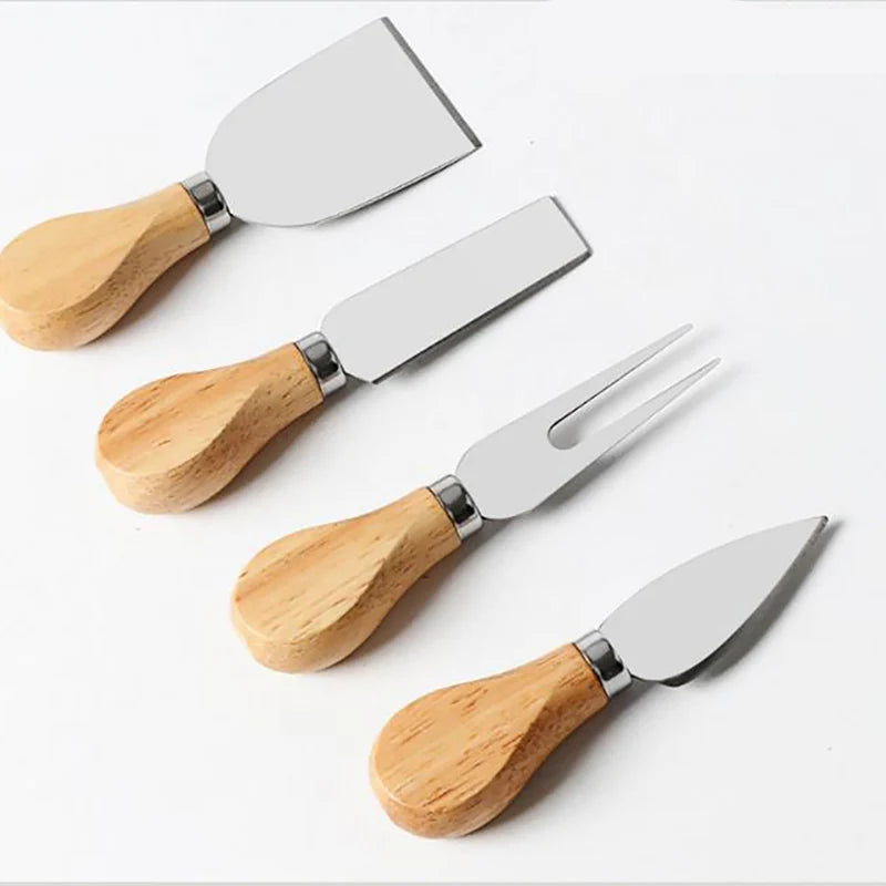 Set of four cheese knives with wooden handles on a white background