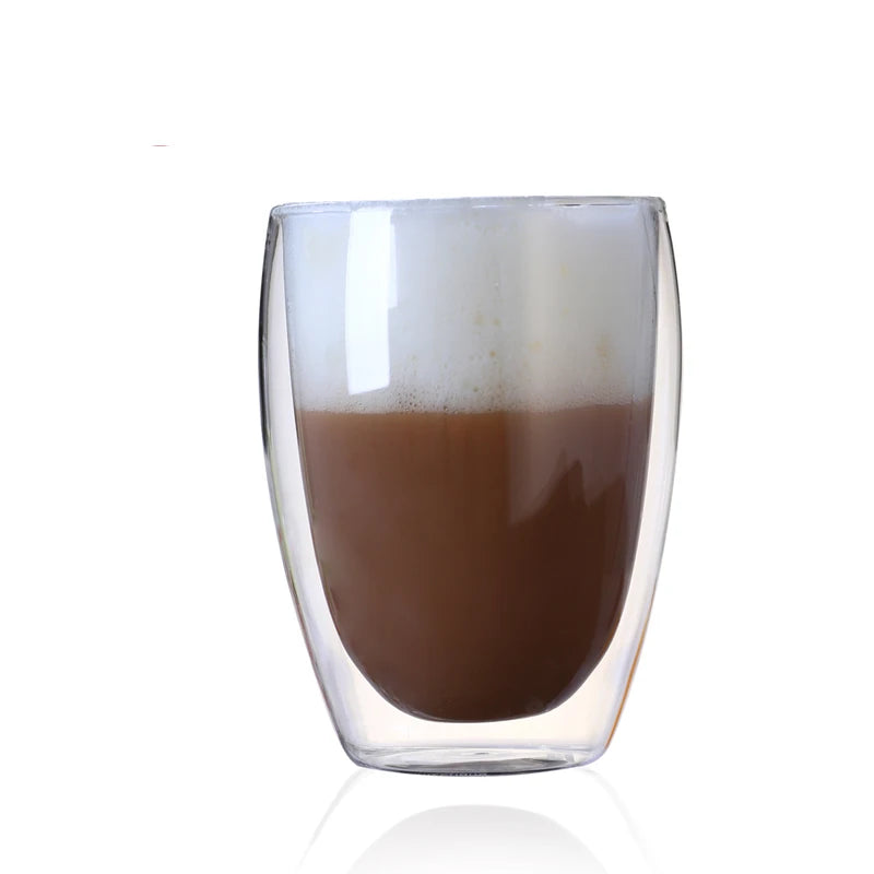 Clear glass tumbler with a brown liquid on a white background