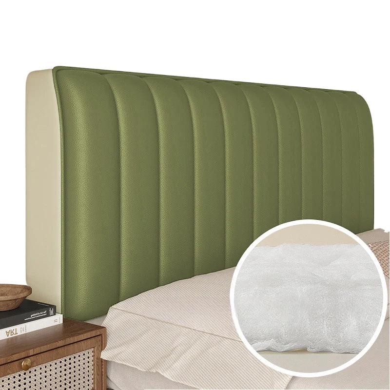 Green upholstered headboard with a close-up of the cushion texture on a bed.