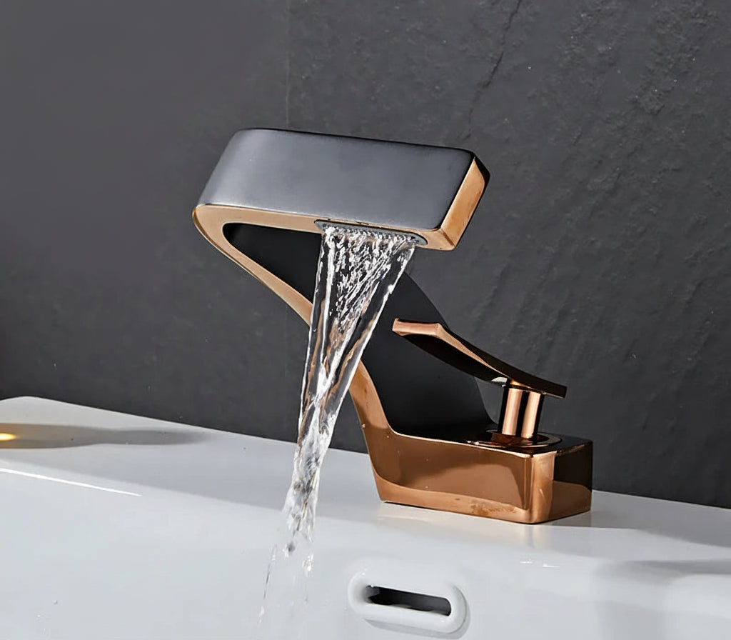 Rose gold and black basin faucet with water flowing, brand 'TOLM' visible