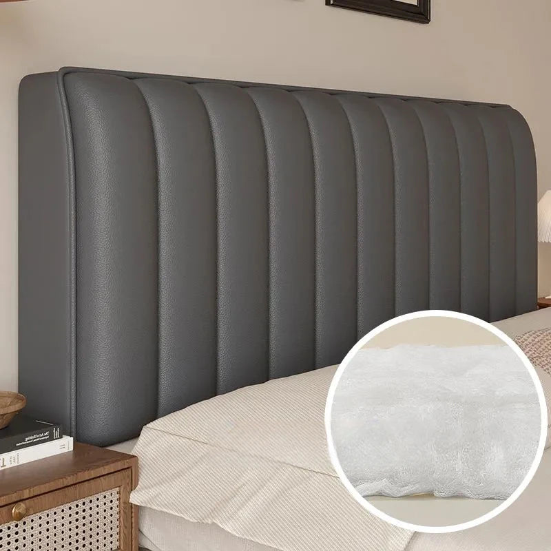 Gray upholstered headboard with a close-up of the cushioned texture on a bed.