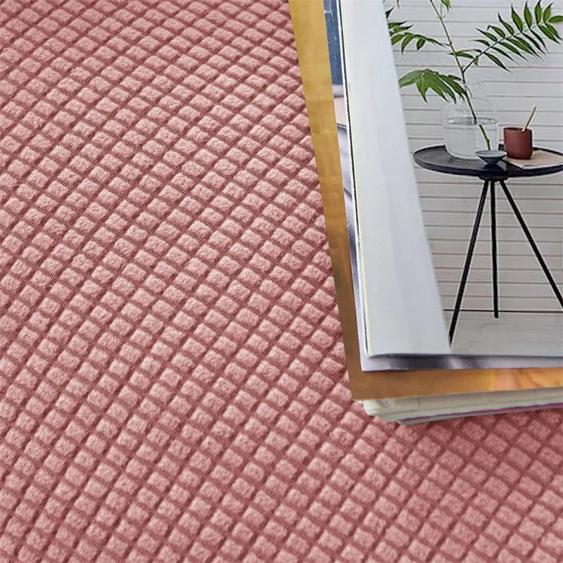 Close-up of a textured pink rug with a magazine on top