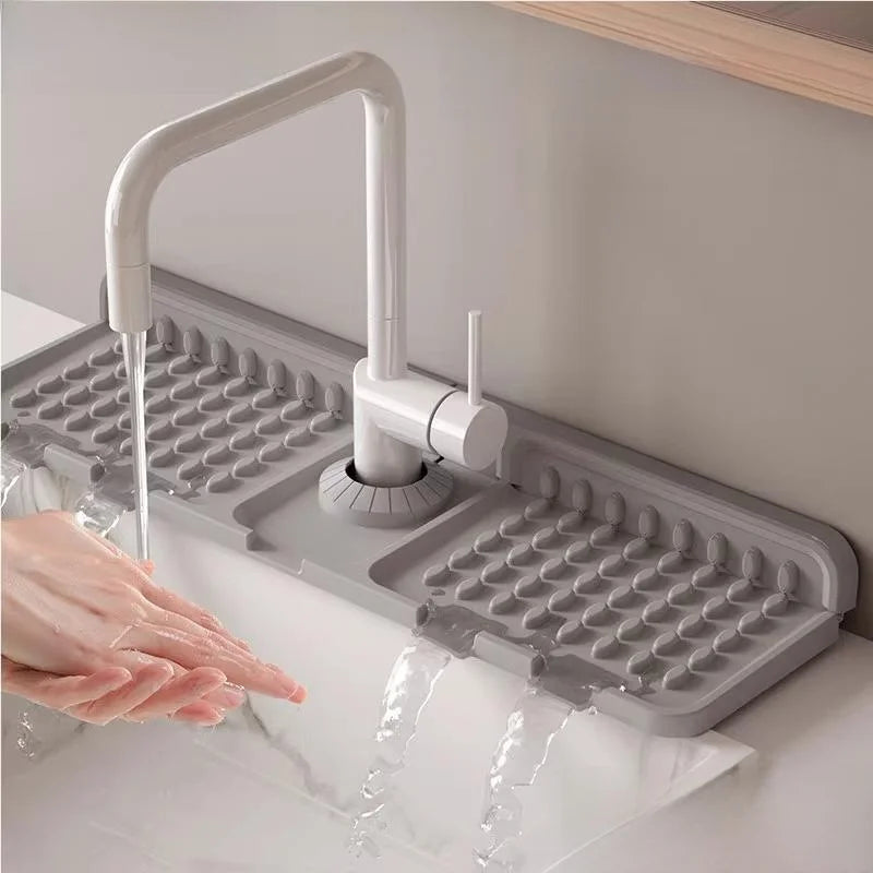 Gray silicone dish drying rack with a faucet over a sink