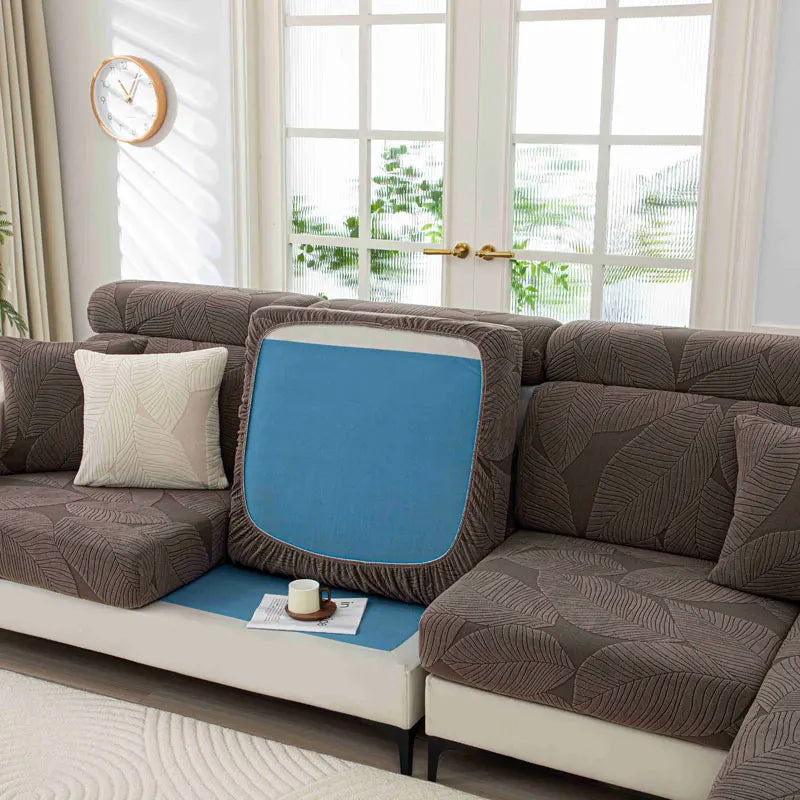 Brown sectional sofa with a blue cushion in a living room setting.