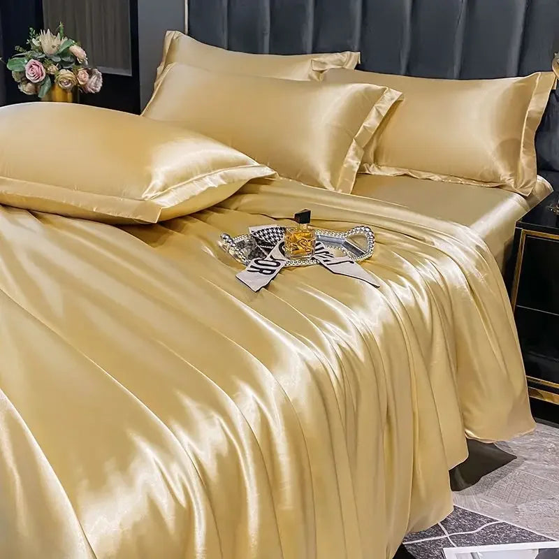 Beige satin bedding set on a bed with decorative pillows and a tray.