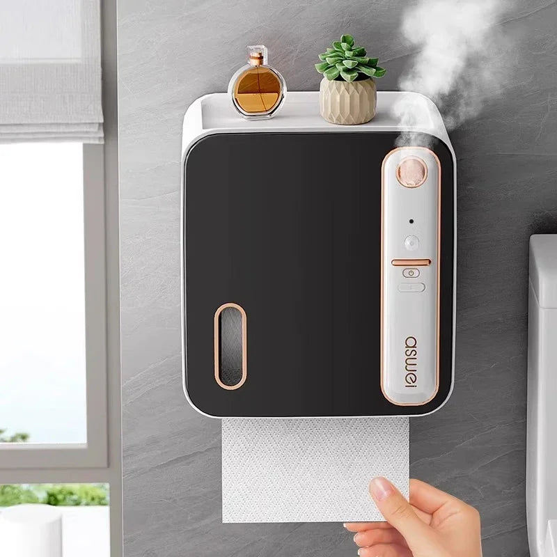 Wall-mounted paper towel holder with steam coming out, placed on a gray surface.