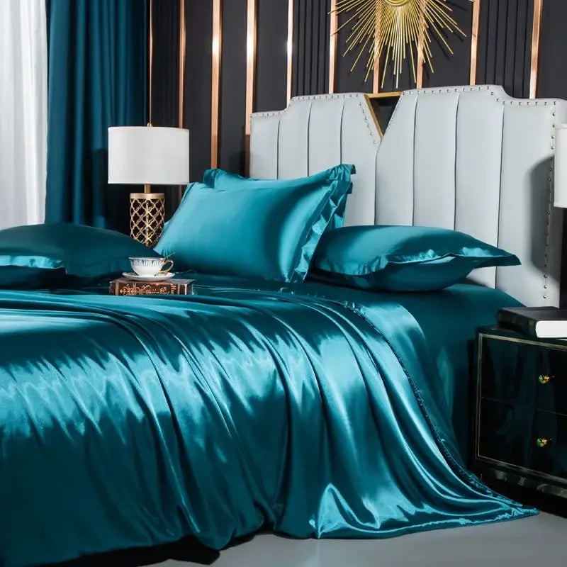 Teal satin bedding set on a bed in a stylish bedroom.