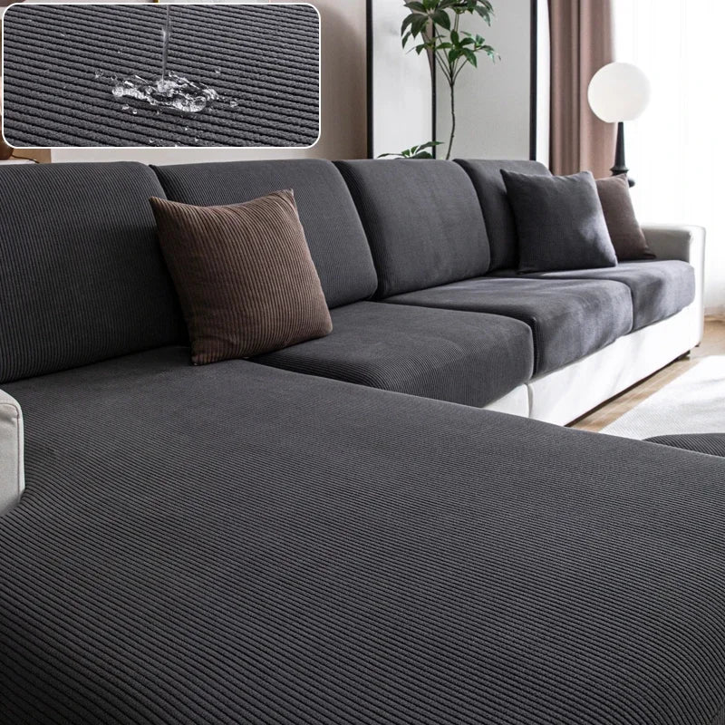 Gray sectional sofa with brown cushions in a living room setting.