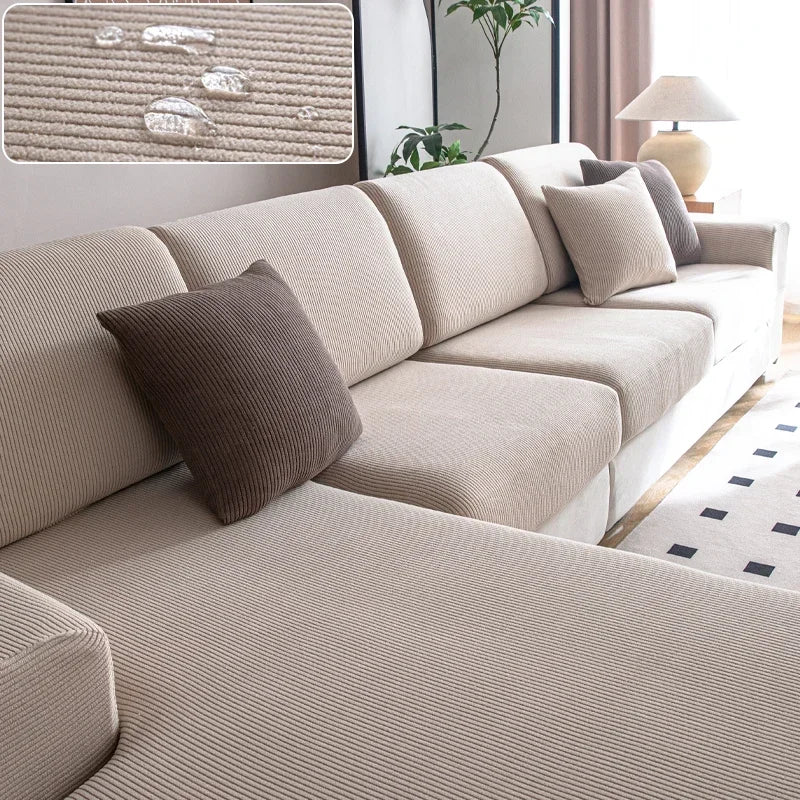 Beige sectional sofa with brown cushions in a living room setting.