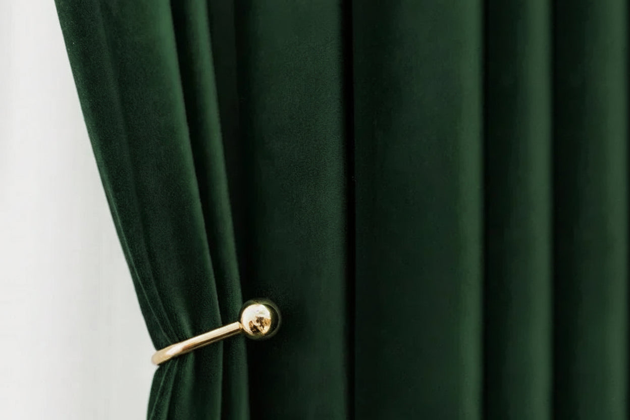 Green curtain with a gold tie-back against a white background, featuring the 'BUWO STUDIOS' brand.