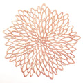Decorative rose gold metal trivet on a white background