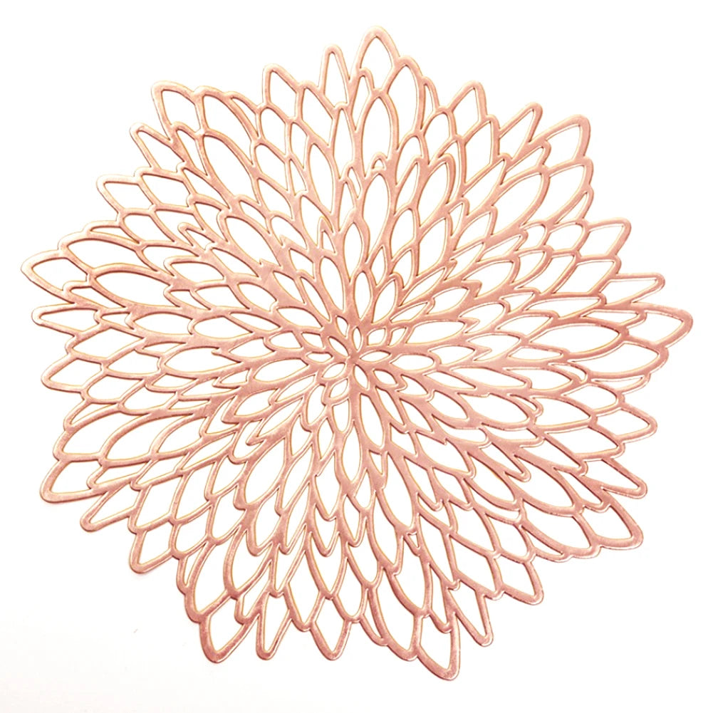Decorative rose gold metal trivet on a white background