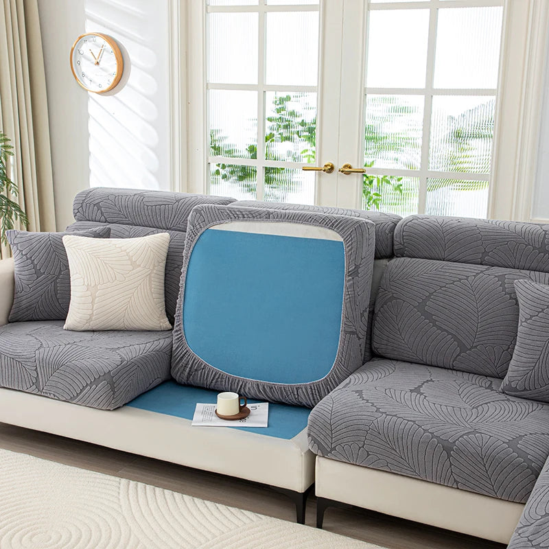 Gray sectional sofa with a blue cushion in a bright living room.