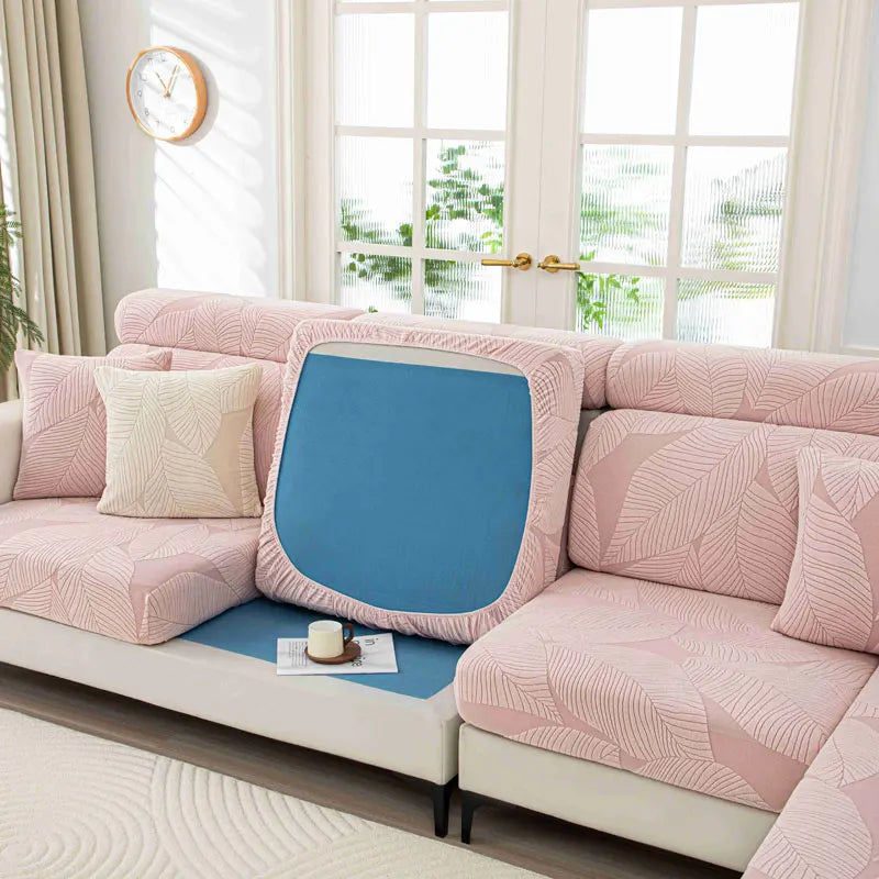 Pink sectional sofa with a blue cushion in a bright living room.