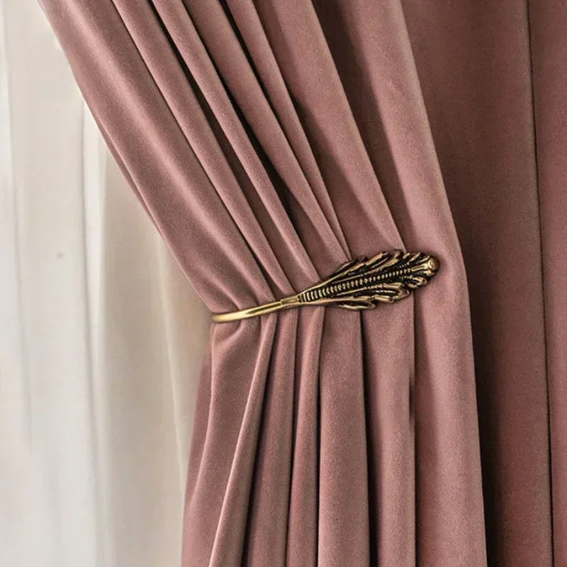 Pink velvet curtain with a decorative gold tieback