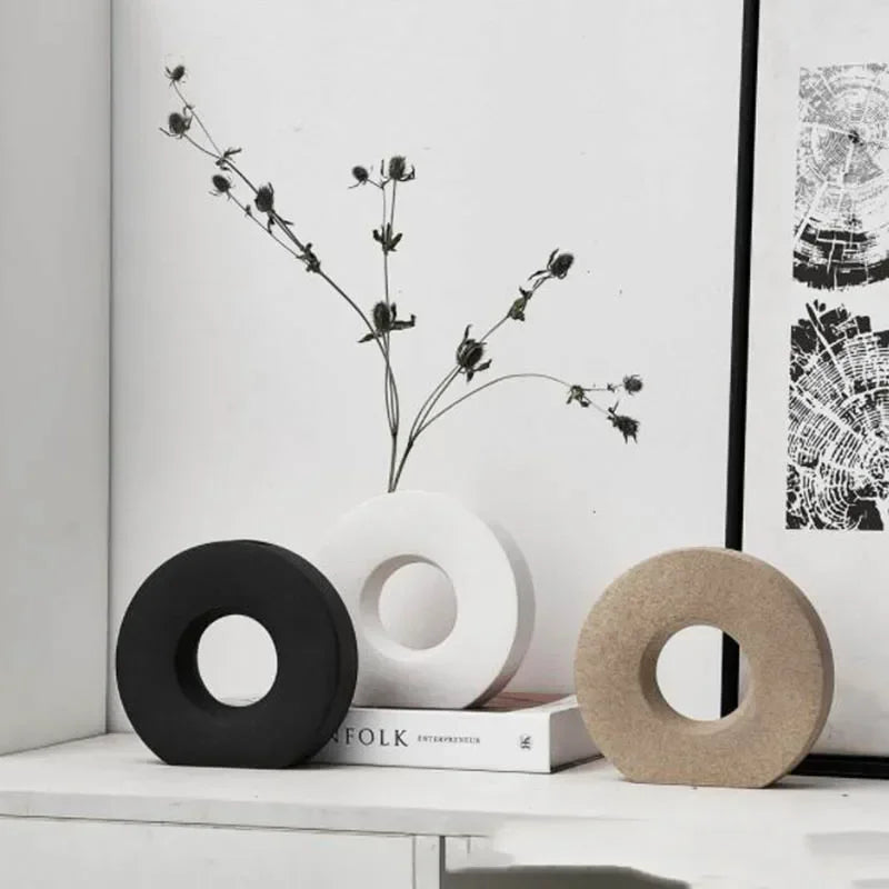 Decorative items on a shelf with black and white wall art in the background