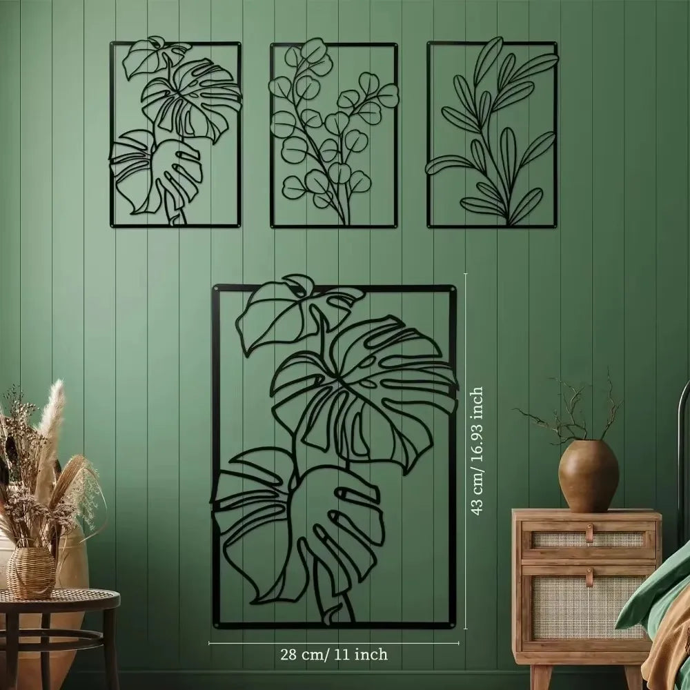 Decorative wall art with leaf designs on a green wall.