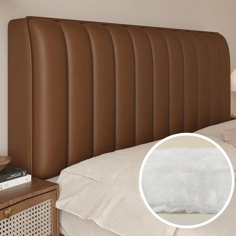 Brown upholstered headboard with a close-up of a textured pillow on a bed.