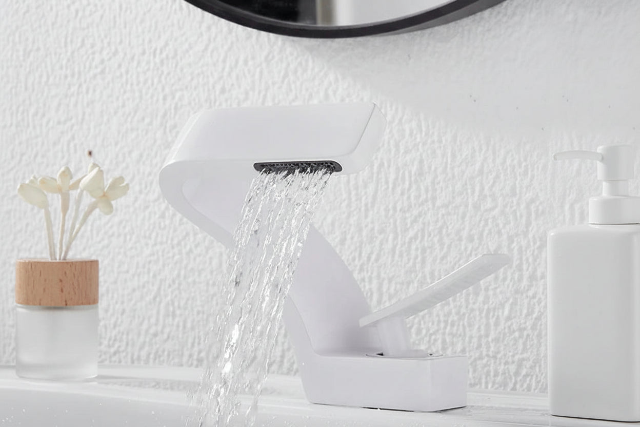 White waterfall hot and cold water faucet with TOLM branding on a textured white wall background.