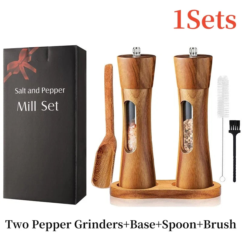 Wooden salt and pepper mill set with packaging, spoon, and brush on a white background.