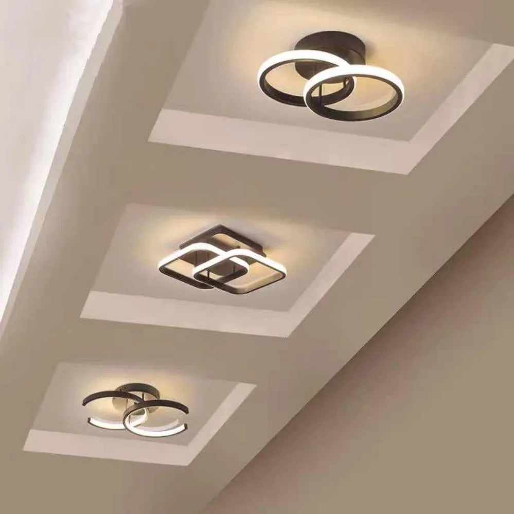 Three modern ceiling lights on a ceiling with geometric design