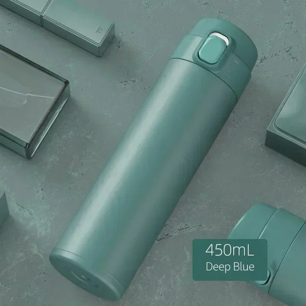 Green thermos bottle with '450mL' and text on a gray surface