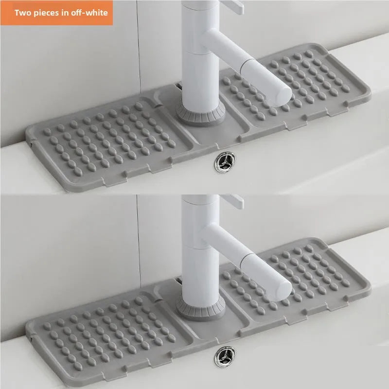 Gray kitchen sink drain mat with a white faucet on a white countertop.