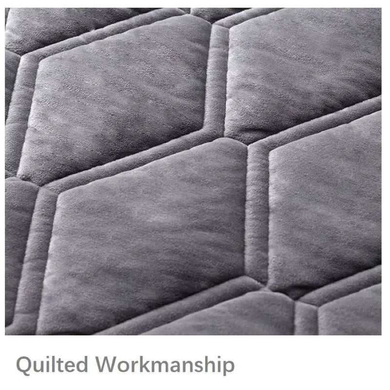 Close-up of a quilted gray fabric surface with 'Quilted Workmanship' text.