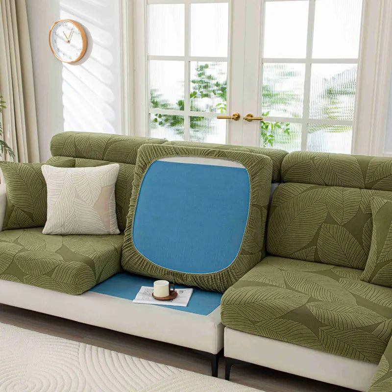 Green sofa with a blue cushion in a living room setting