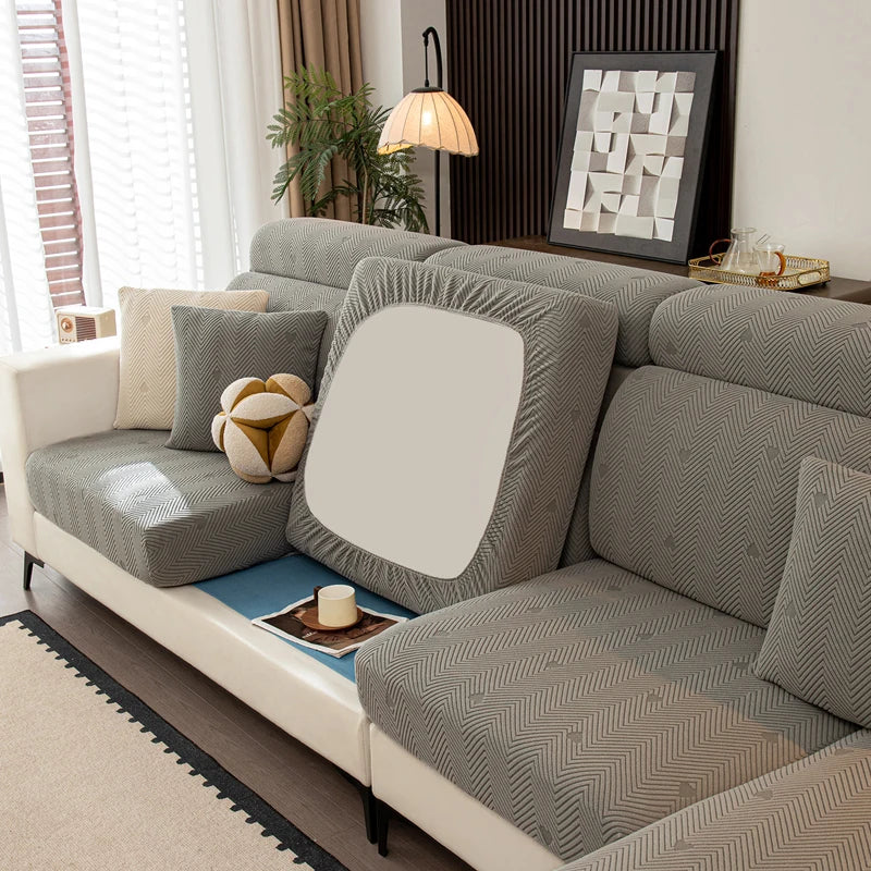 Gray sectional sofa with decorative pillows in a living room setting.