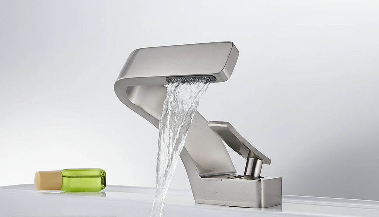 Brushed nickel waterfall faucet with water flowing, TOLM brand visible