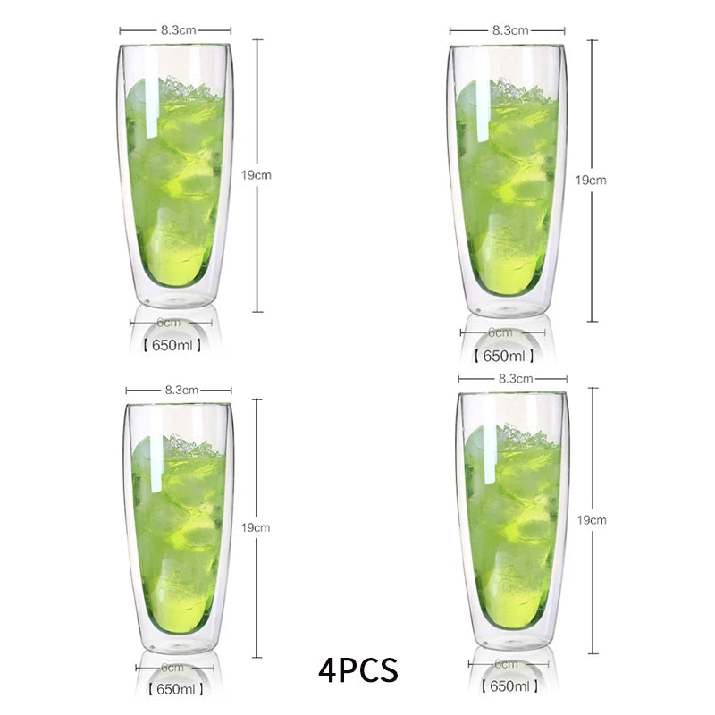 Four double-walled glass tumblers with green liquid and measurements on a white background