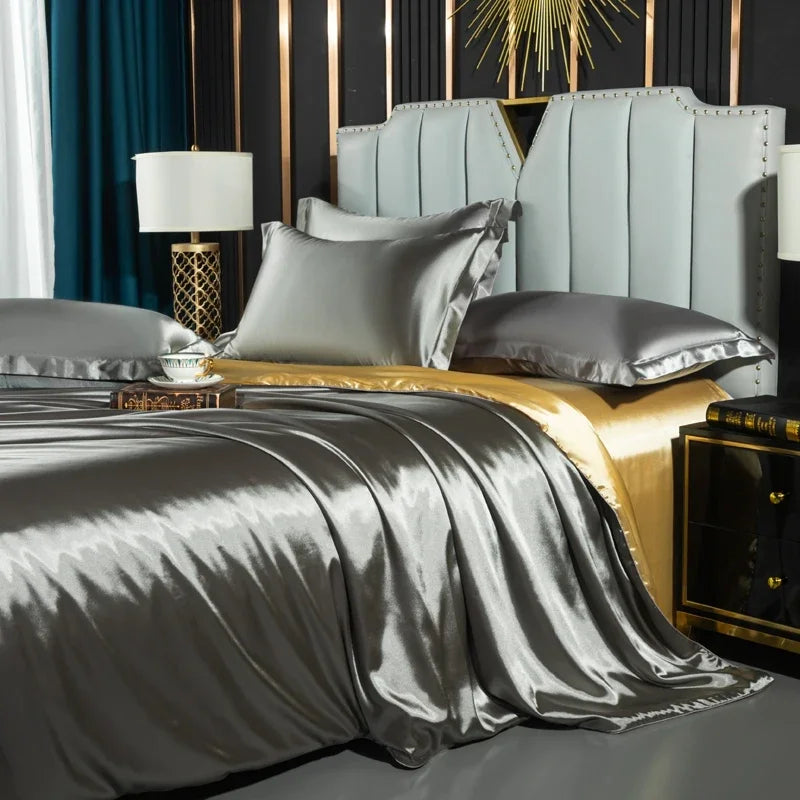 Luxurious bedroom with a bed featuring gray bedding and pillows, gold nightstands, and decorative elements.