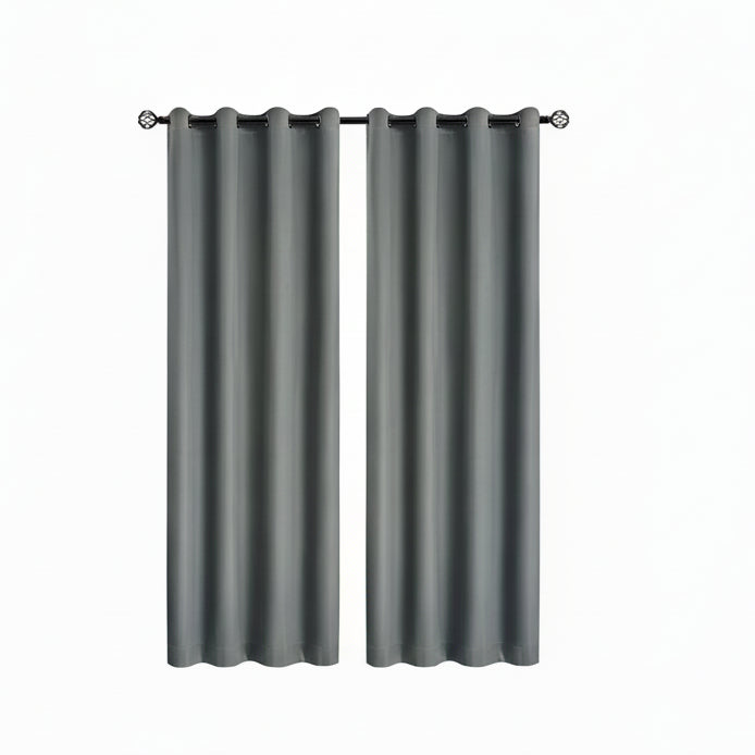 Gray blackout curtains with a black panel pulled down in a room with a couch and window.