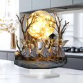 Decorative lamp with fairy figures and a full moon in a kitchen setting