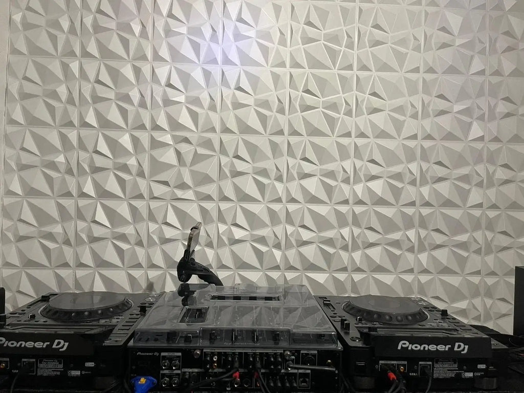 DJ equipment on a turntable with a geometric patterned wall in the background