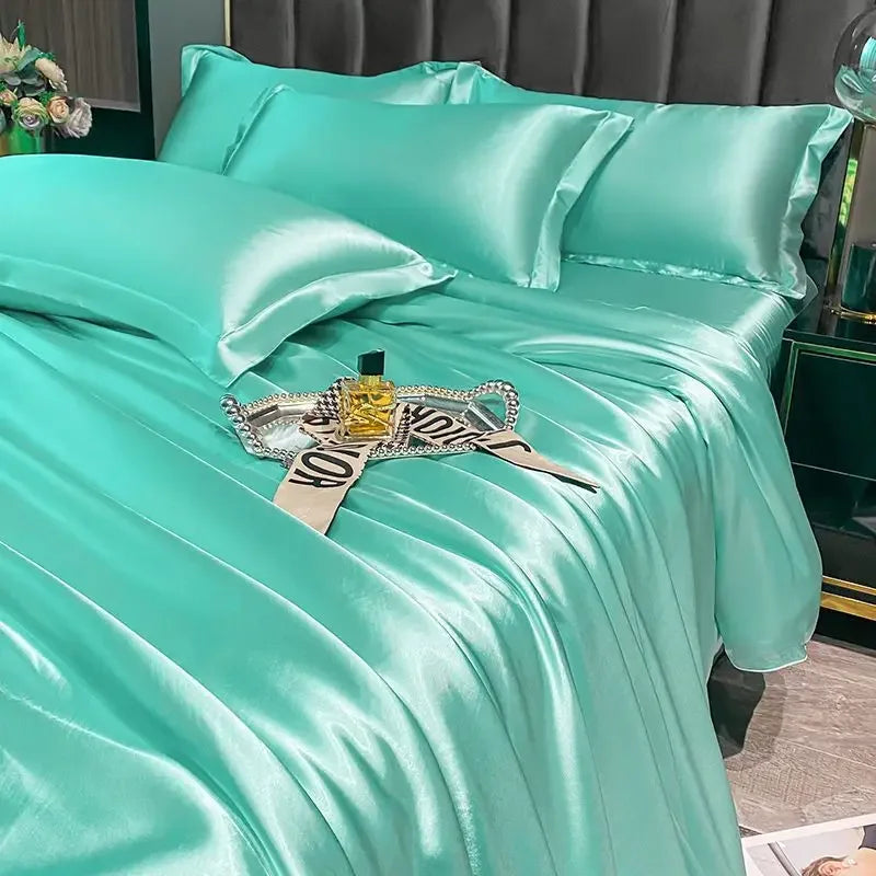 Turquoise satin bedding set on a bed with decorative items.