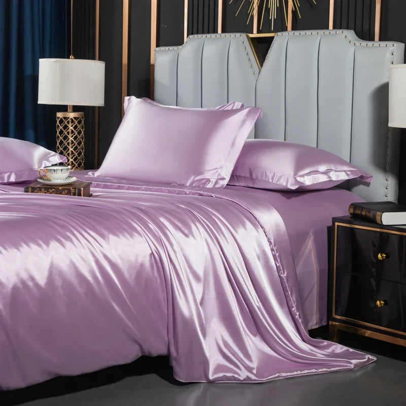 Purple satin bedding set on a bed with a gray headboard and decorative elements.