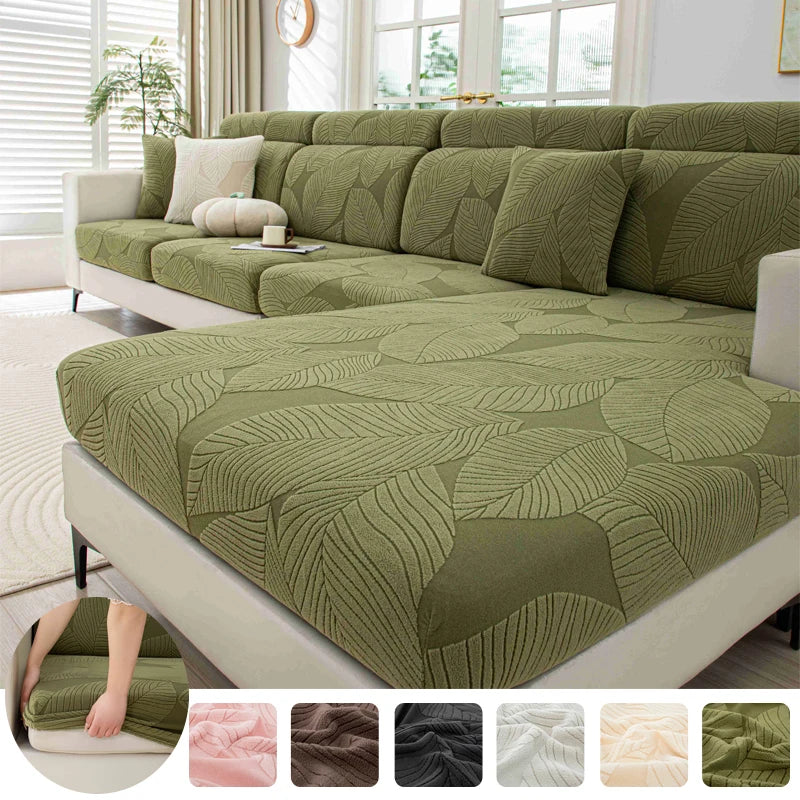 Green leaf-patterned sofa cover on a sectional sofa in a living room.