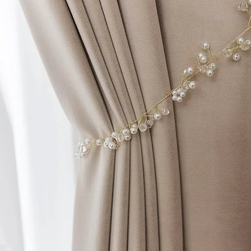 Decorative pearl and crystal curtain tieback on a beige curtain