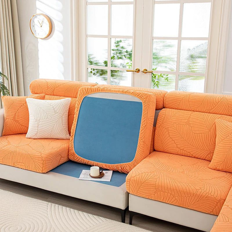 Orange sectional sofa with a blue cushion in a living room setting.