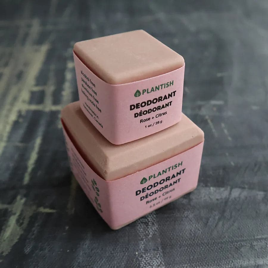 Two pink deodorant bars with 'Plantish' branding on a textured gray background