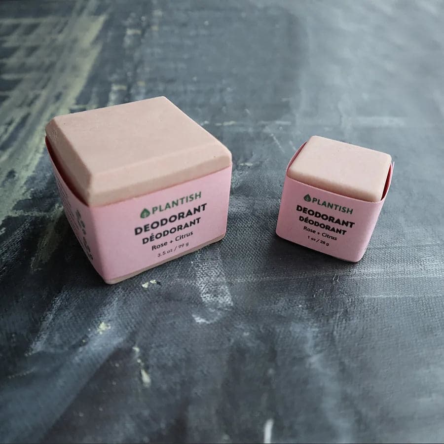 Two pink deodorant containers with 'Plantish' branding on a textured surface.