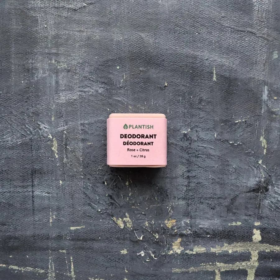 Pink deodorant bar with 'Plantish' branding on a textured black background